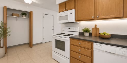 Kitchen with white appliances at {location_name}} in Urbandale, Iowa