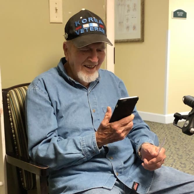 Resident facetiming family at Grand Villa of Pinellas Park in Pinellas Park, Florida