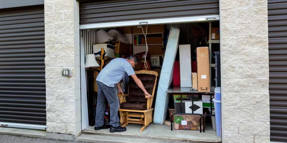 Man storing belongings into storage unit at Affordable Storage in Independence, Oregon