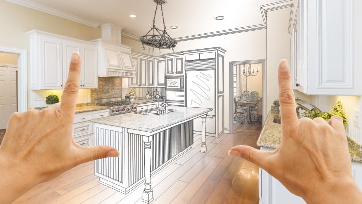 hands framing an open kitchen layout
