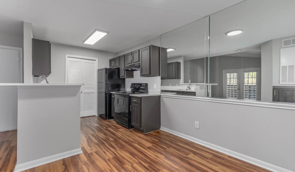 Open-concept kitchen and living area at Oaks of Kingwood Apartments in Kingwood, Texas