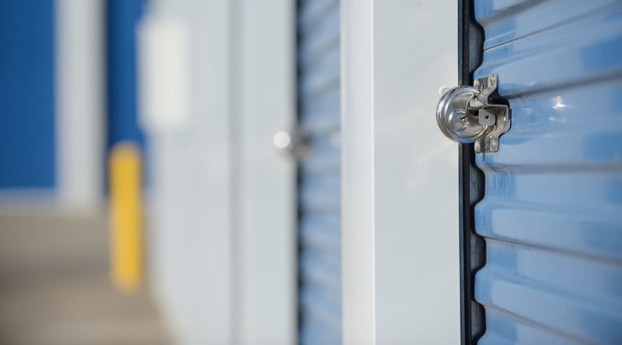 Storage units with blue doors and locks at KO Storage in Azle, Texas