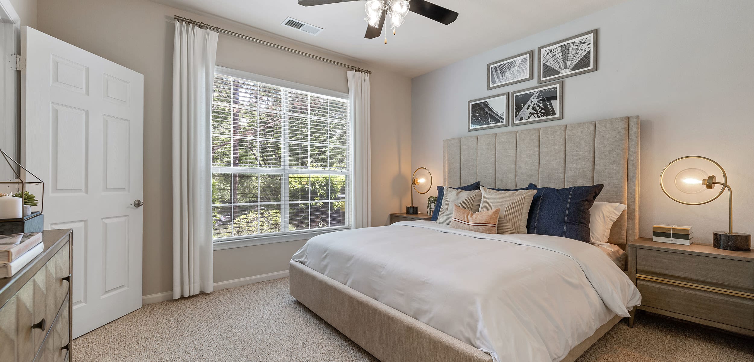 Carpeted bedroom with big window at Marquis at Carmel Commons in Charlotte, North Carolina
