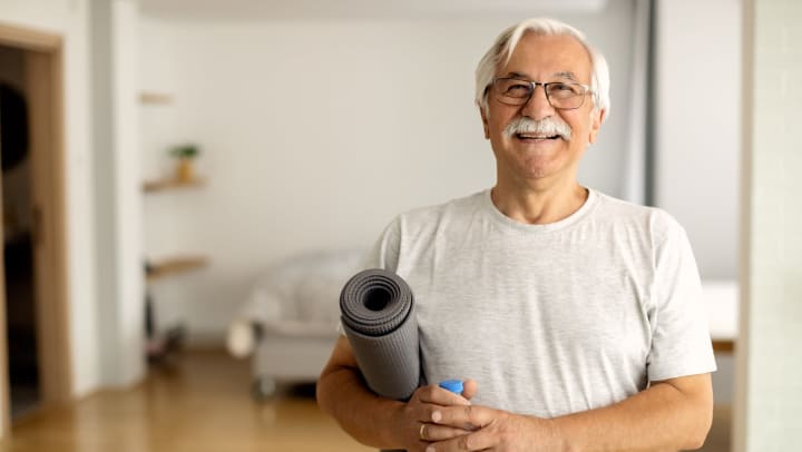 older gentleman with a yoga mat