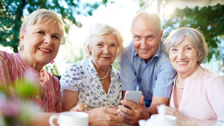 Four senior people taking a picture