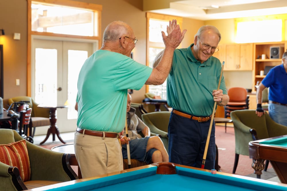 Friends in the billiard room at Touchmark at Meadow Lake Village in Meridian, Idaho