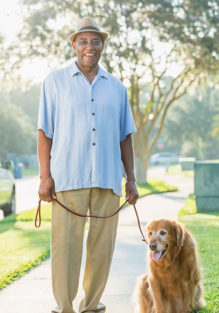Resident and caregiver pose for a picture together at Cascade Valley Senior Living in Arlington, Washington