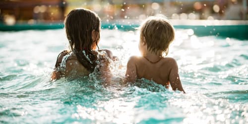 Kids enjoying the year-round swimming pool at M2 Apartments in Denver, Colorado