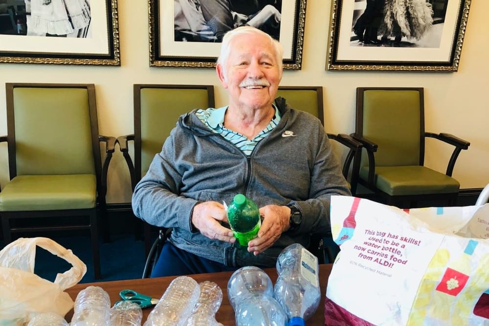 A resident making a bottle art project at CERTUS Premier Memory Care Living in Orange City, Florida.
