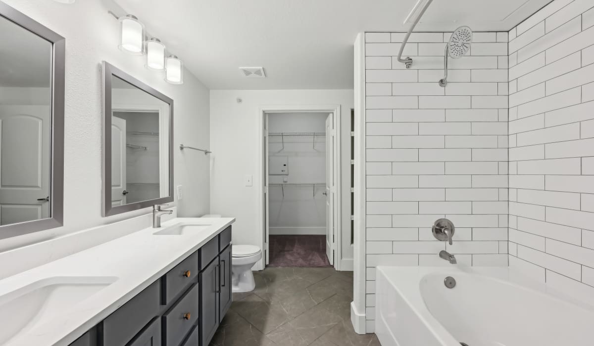 Bright bathroom with shower and tub at Barron Park in Pearland, Texas