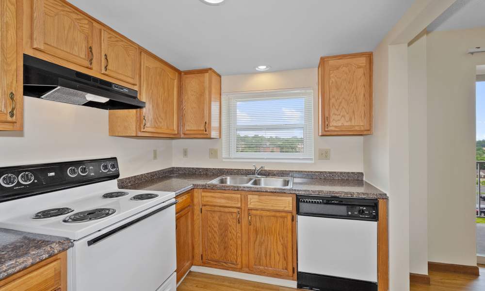 Modern kitchen with wooden cabinets at Vantage Pointe West Apartment Homes in Cincinnati, Ohio