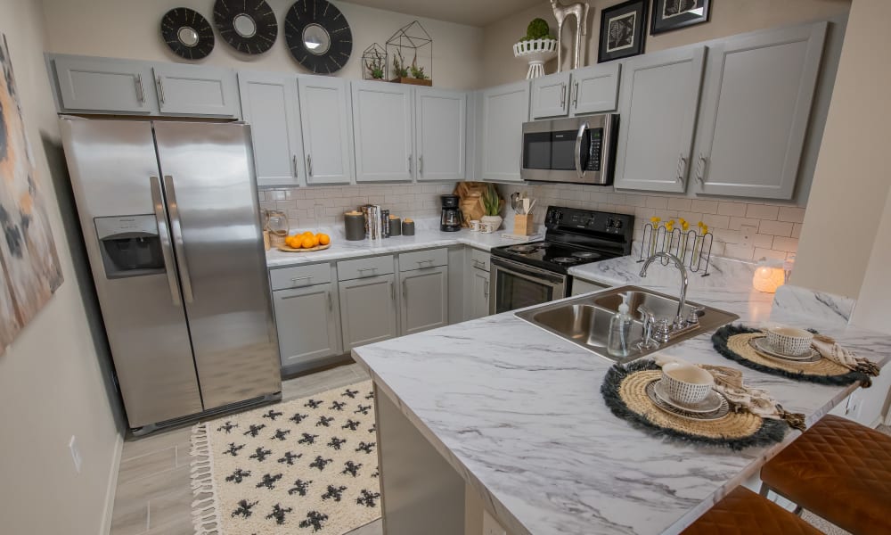Fully-equipped kitchen at Bend at New Road Apartments in Waco, Texas