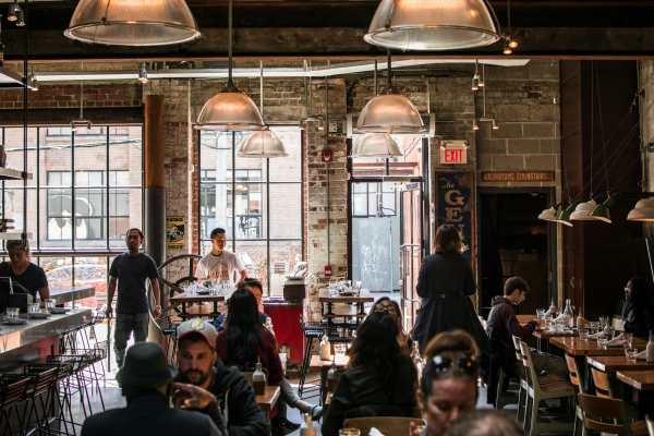 Residents enjoying food at a restaurant near  The Lofts At West 7th in Fort Worth, Texas 
