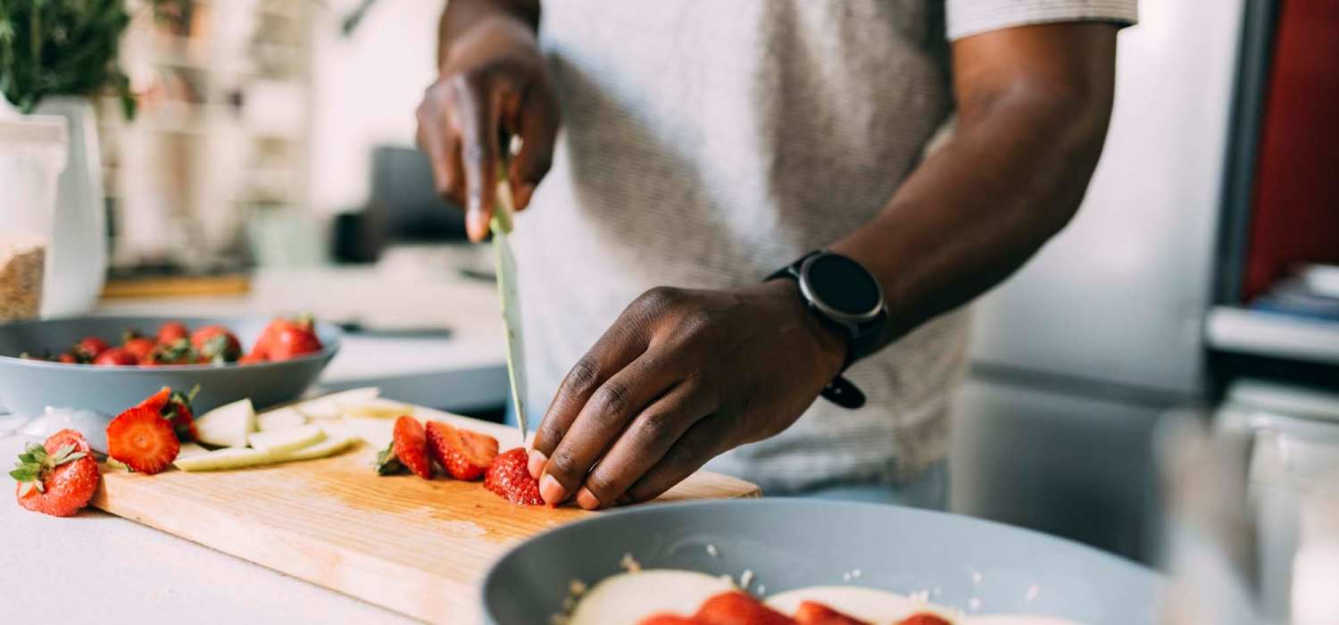 Resident chopping vegetables at Spring Hollow Apartments in Brighton, Colorado