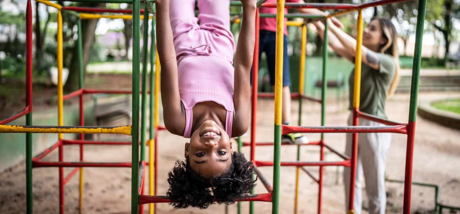 A kid spending her time in playground at Village Apartments in Bellaire, Michigan