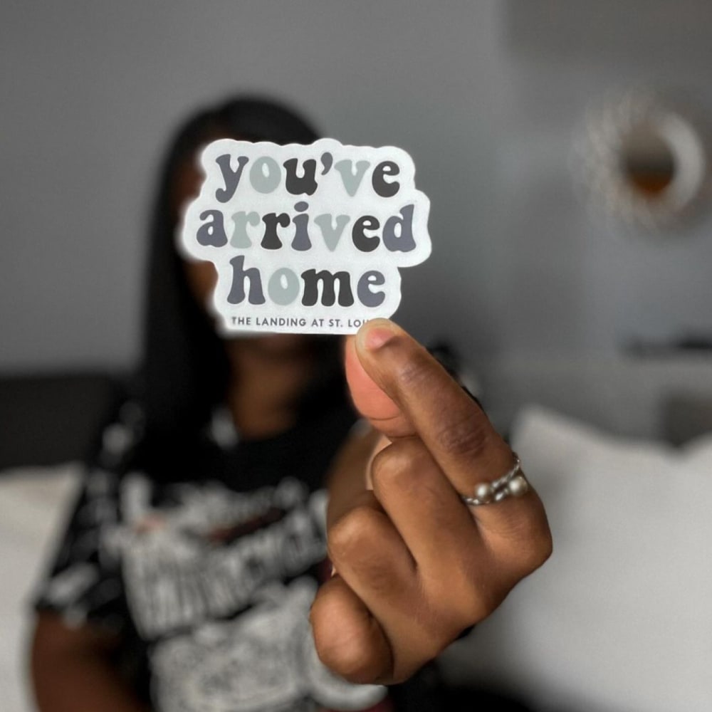 Staff holding a sticker at The Landing St. Louis in Saint Louis, Missouri