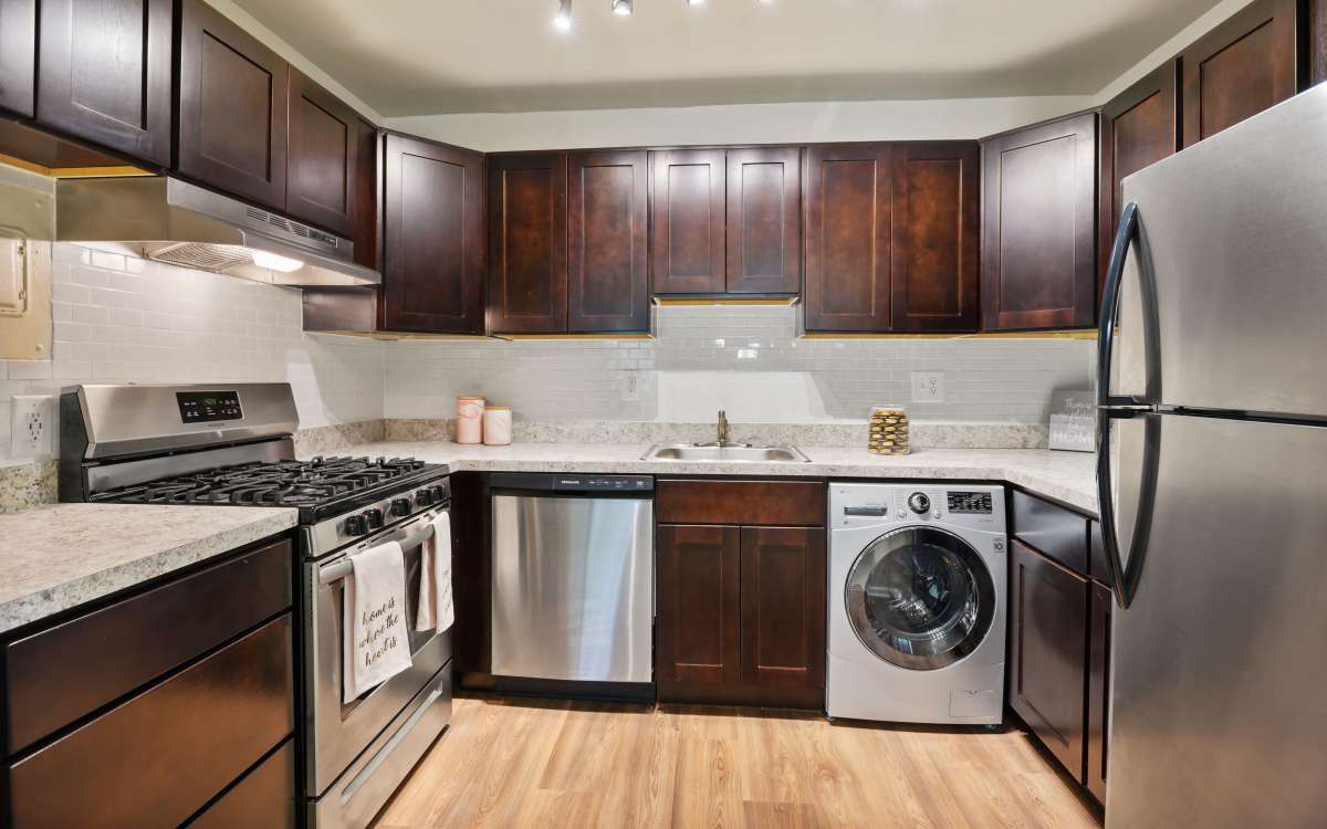 Kitchen room with modern appliances and a washing machine at Cross Creek in Laurel, Maryland