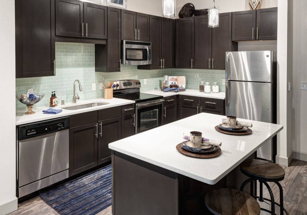 Enjoy a modern kitchen with breakfast bar at Axis 3700 in Plano, Texas