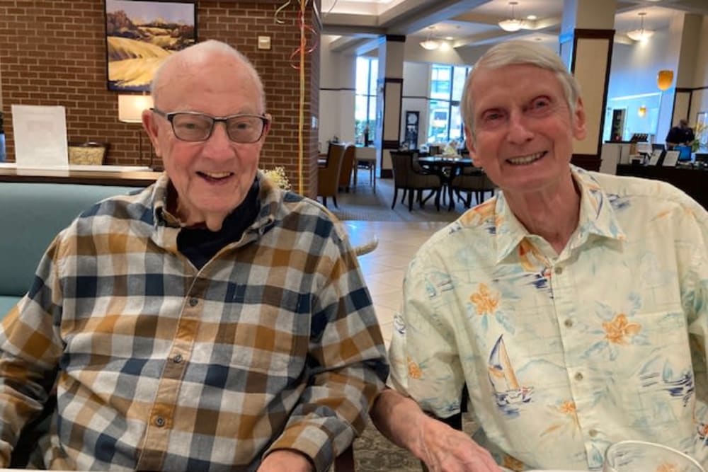 Two seniors smiling for a photo 