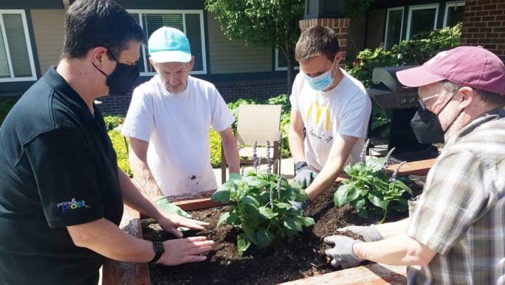 Harvester Place Memory Care Planting Flowers with Local Volunteers