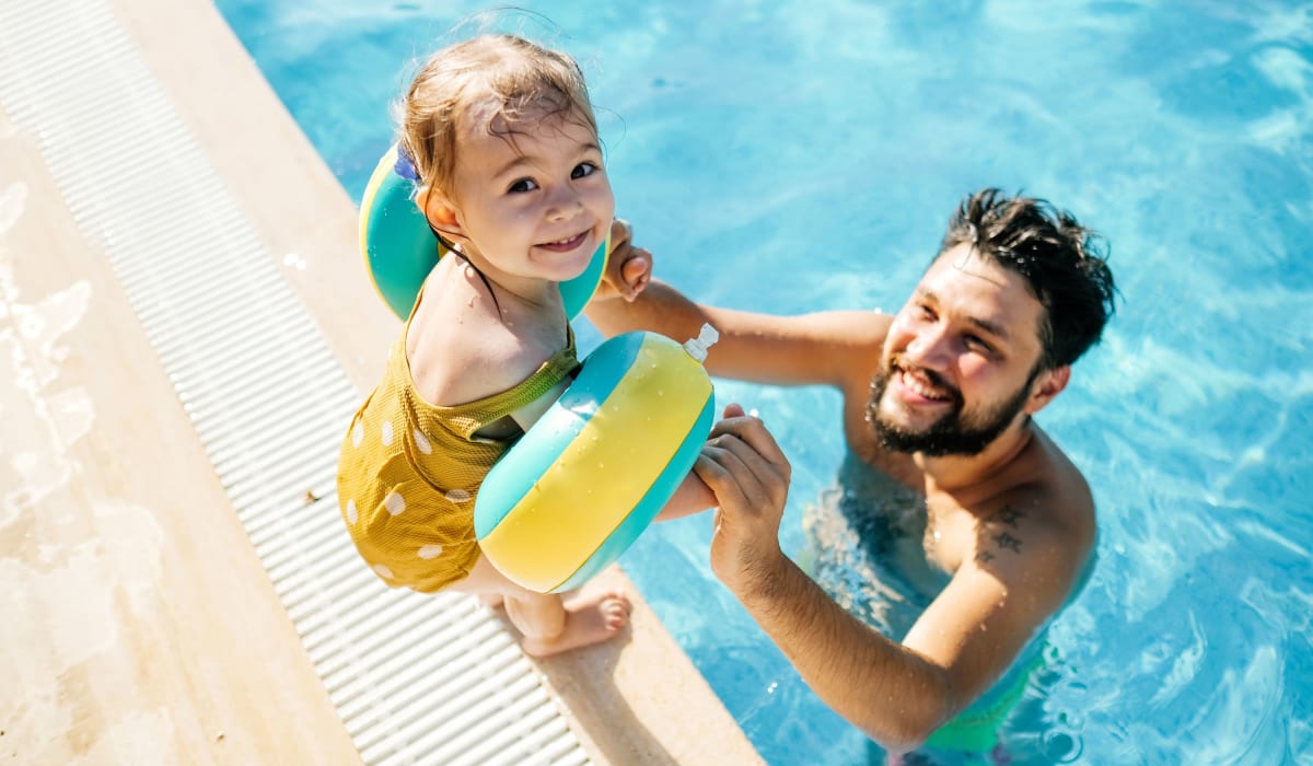 Dad and child playing in the pool at Park Sorrento in Bakersfield, California