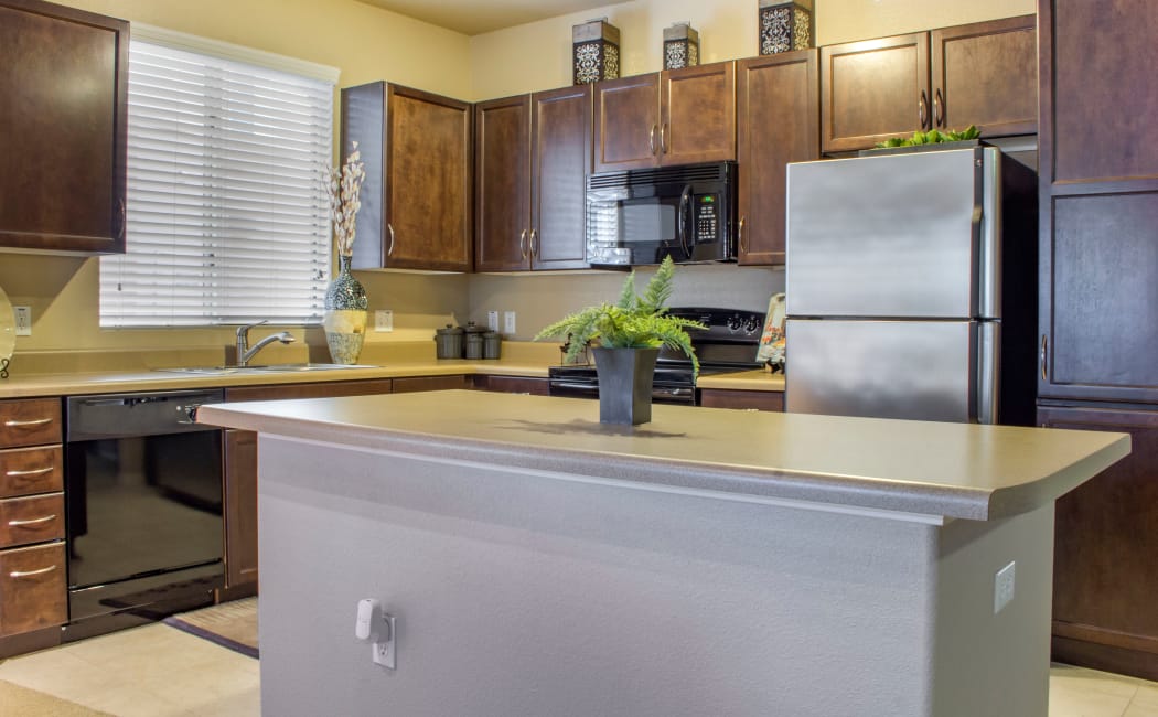 Modern kitchen with built-in island in model home at The Residences at Stadium in Surprise, Arizona