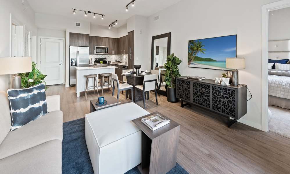 Light modern style kitchen and dining area with a breakfast bar at 6600 Main in Miami Lakes, Florida