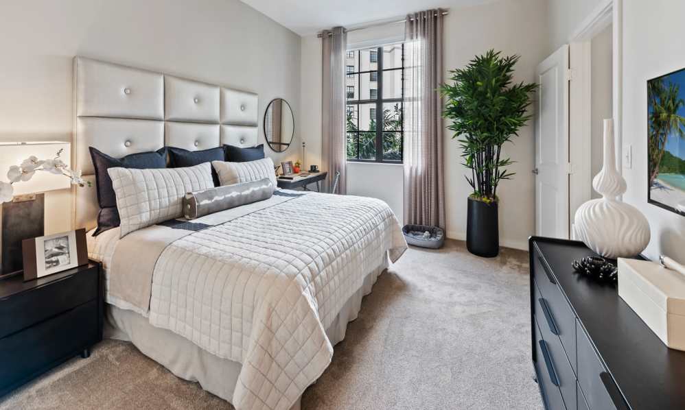 Bedroom with carpet and dark ceiling fan in model home at 6600 Main in Miami Lakes, Florida