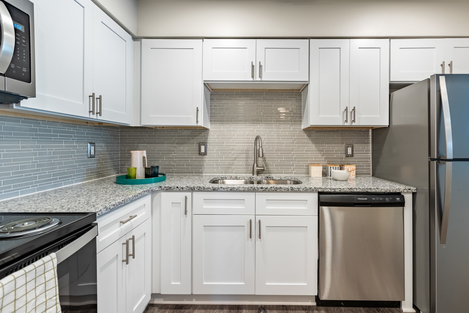 Kitchen with modern white cabinets and stainless steel appliances at Regency Lakeside Apartment Homes in Omaha, NE