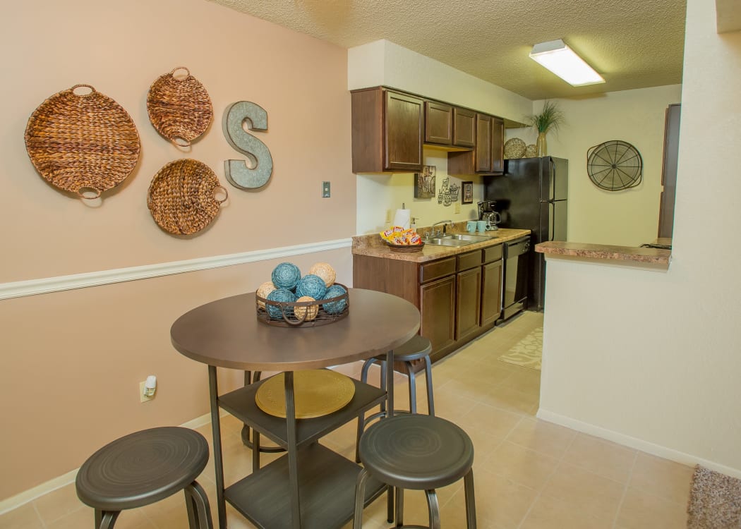 View of modern kitchen from dining area of model home at Sugarberry Apartments in Tulsa, Oklahoma