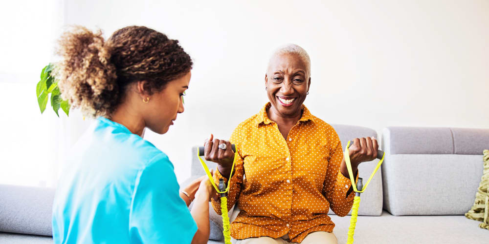 A staff member helping a resident stretch at Careage Home Health in Bellevue, Washington. 