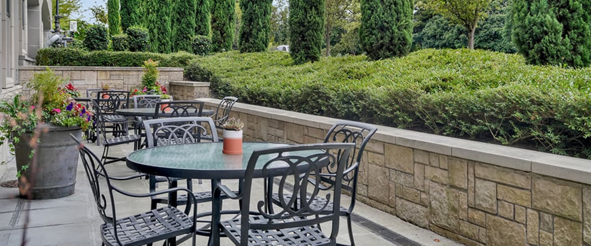 Outdoor seating with tables and chairs at The Bellettini in Bellevue, Washington