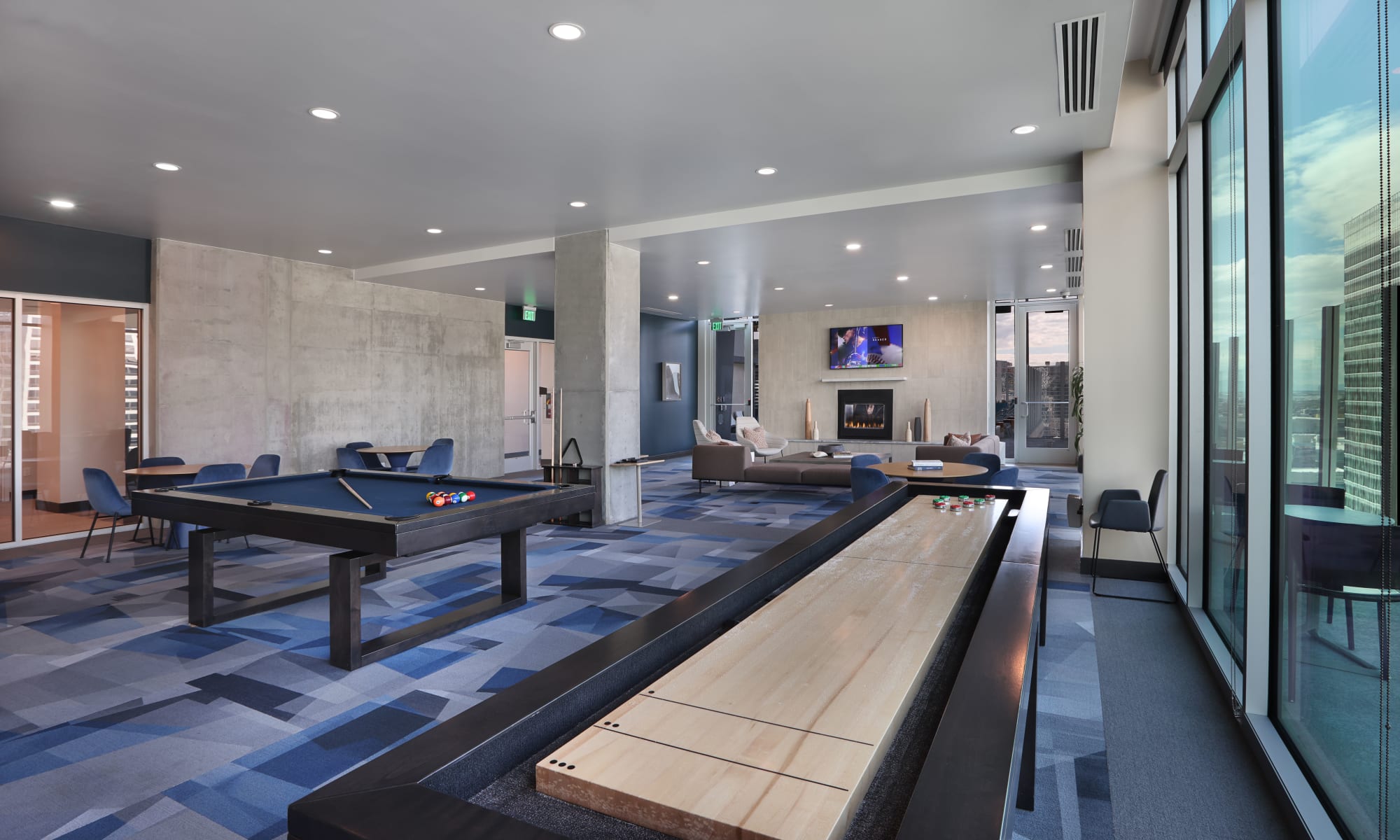 21st floor rooftop clubroom with shuffleboard, pool and lounge area with tv and fireplace at Luxury high-rise community of Liberty SKY in Salt Lake City, Utah