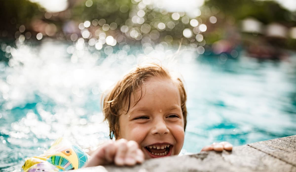 Kid playing in the pool at Towne Centre Apartments in Lathrop, California