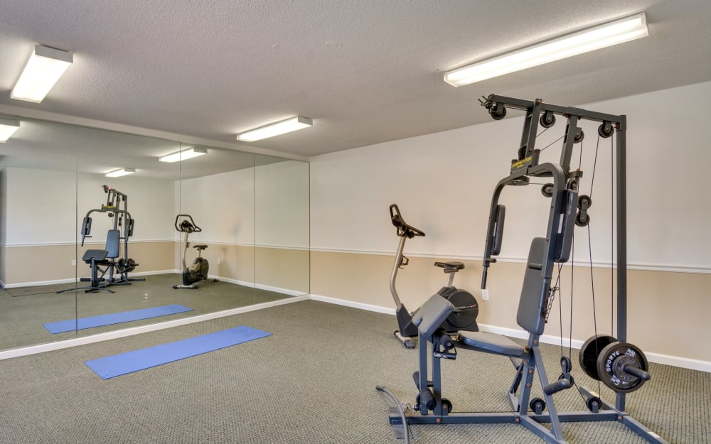 Well-equipped fitness center with cardio equipment at Woodbrook Apartment Homes in Monroe, North Carolina
