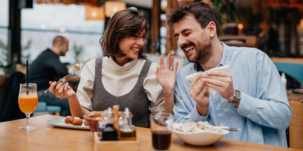 A happy couple having meal at their favorite restaurant near The Calvert in Charlotte, North Carolina