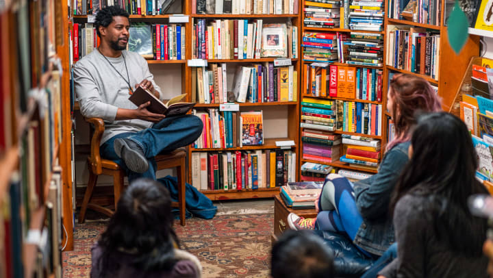 a man leading a group book discussion in a bookstore | bookstores in Sarasota 