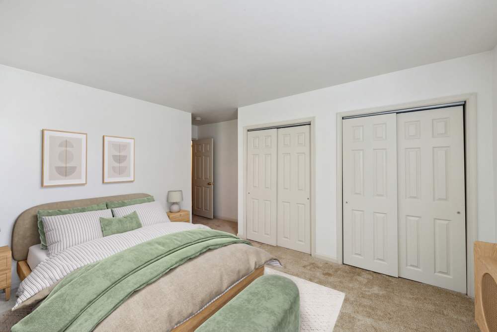 bedroom with wall to wall carpeting and large closets