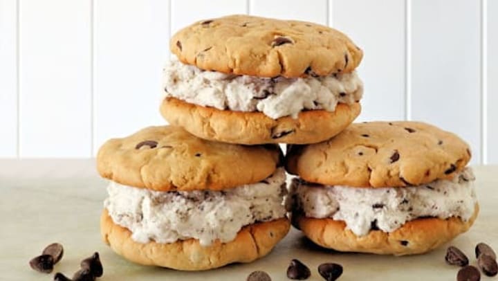 Chocolate chip cookie ice cream sandwiches against a white background.