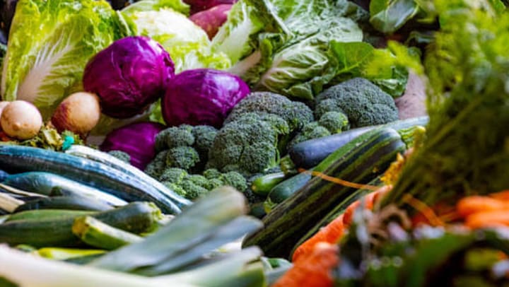 A delicious assortment of fresh vegetables, including broccoli, purple cabbage, cucumbers, and squash found at the farmers markets in Charlotte