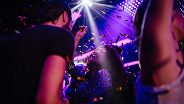 Friends dancing at a nightclub with colorful confetti | nightclubs in Central Sachse