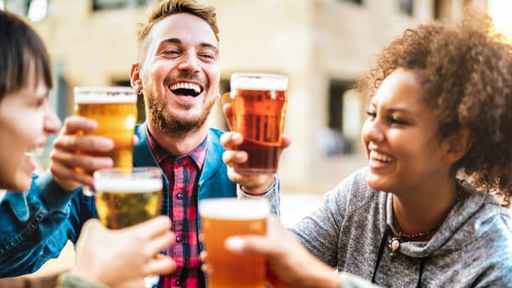 friends toasting beers at Panther Island in Fort Worth