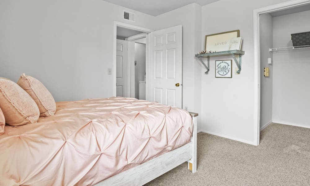 Bedroom  with bright duvet at The Remington Apartments in Wichita, Kansas