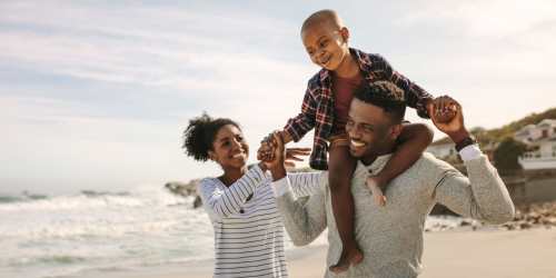 A couple with their child on a beach near Hawk's Landing in Fort Myers, Florida