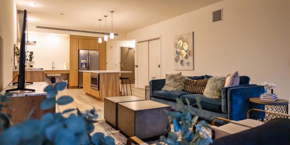 A furnished apartment living room and a modern kitchen at The Beacon in Cleveland, Ohio