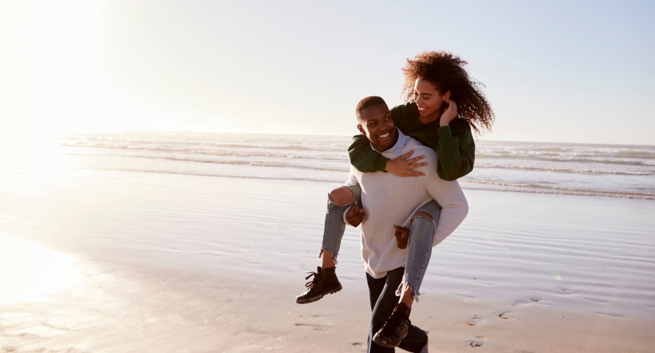 Couple hanging out at the beach near Cottage Place Apartments in Long Branch, New Jersey