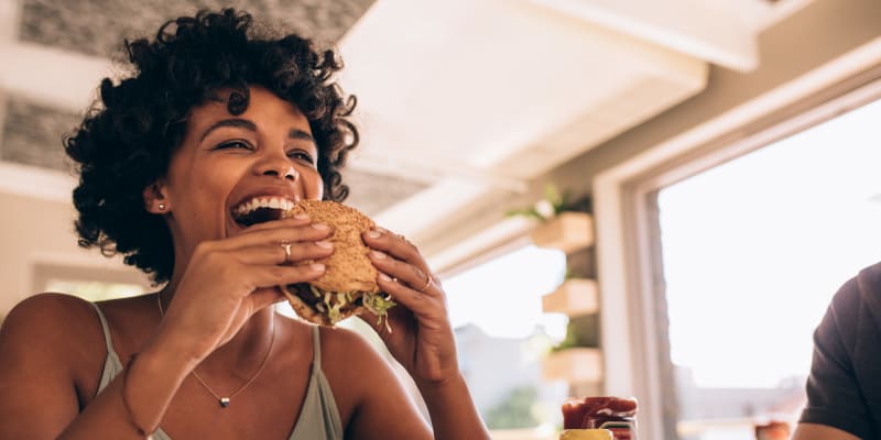 A resident eating burger at restaurant near Chollas Heights Historical in San Diego, California