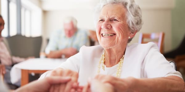 Resident smiling ear to ear in the dining room at Retirement Ranch in Clovis, New Mexico