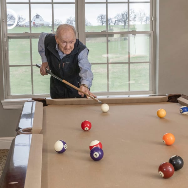 man playing pool at The Castlewood Senior Living in Nixa, Missouri