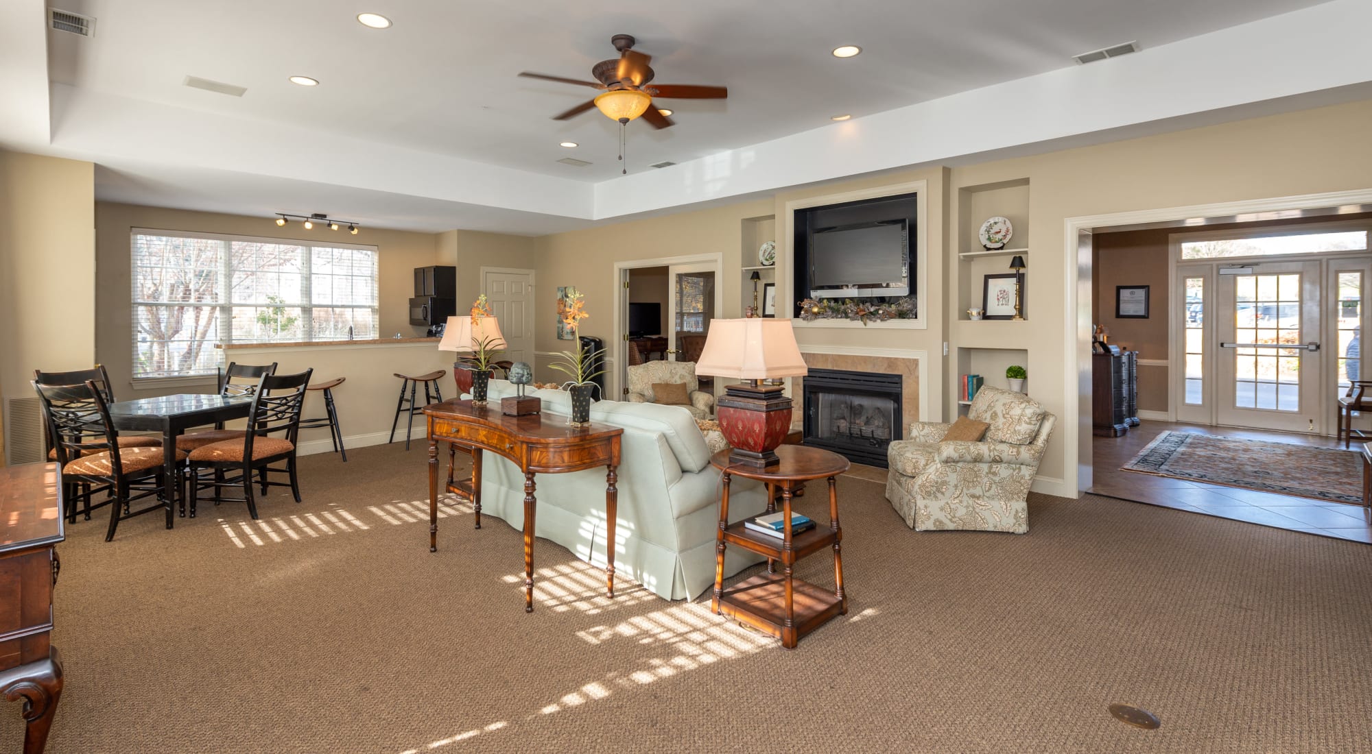Spacious resident lounge with a flat-screen TV and fireplace at The Overlook at Stonemill in Lynchburg, Virginia